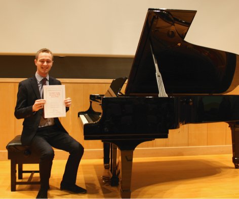 Pianist holding certificate